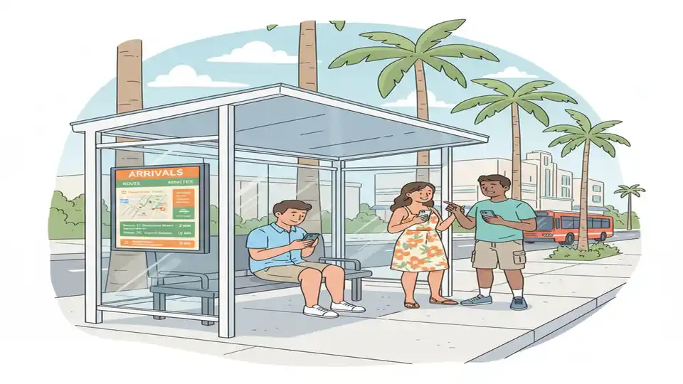 Transit rider checking smartphone for real-time bus arrival information at covered bus shelter, digital display board showing route schedules in background