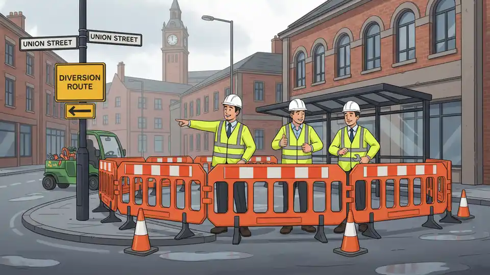 Bus station barriers under maintenance with work crew visible, Union Street and Jacobs Well Lane intersection in frame showing diversion route
